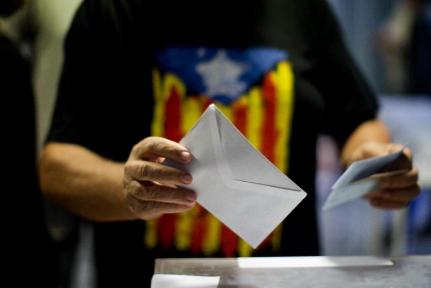 A man votes at a polling station in Barcelona, Spain, Sunday Sept. 27, 2015. Voters in Catalonia go to the polls on Sunday to elect regional lawmakers, with pro-secession parties saying they will push for independence within 18 months if they win a majority in the 165-seat parliament, as most opinion polls predict they will. (AP Photo/Emilio Morenatti)